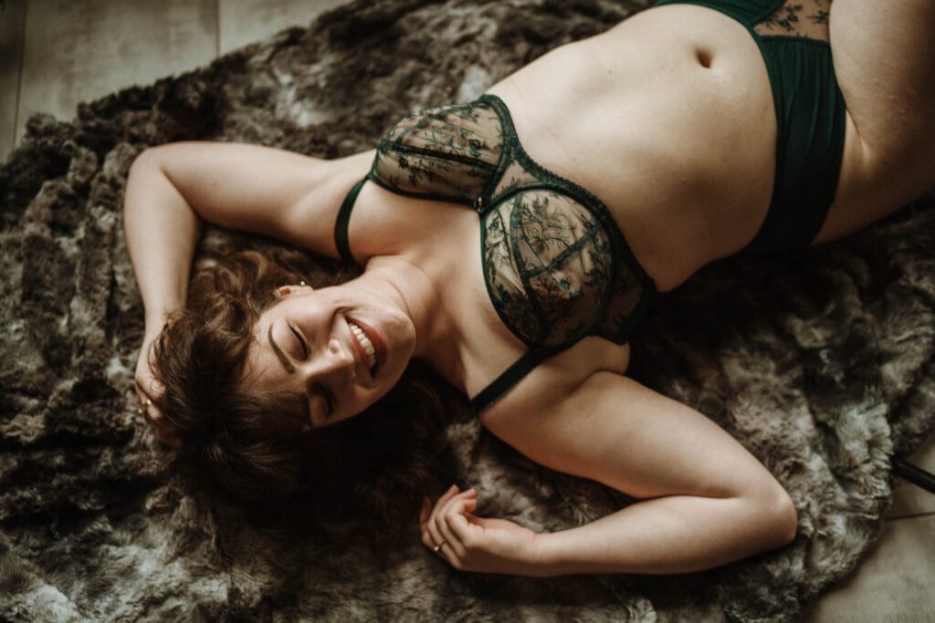 Girl laughing laying down in lingerie